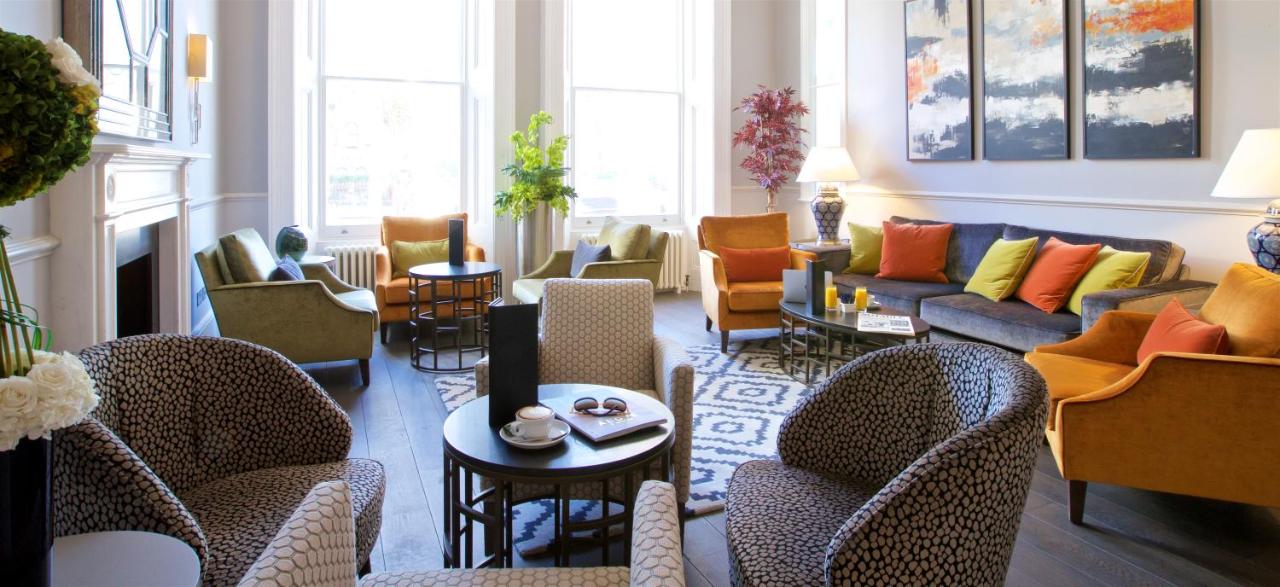 a living room with chairs and couches at 54 Queen's Gate Hotel in London