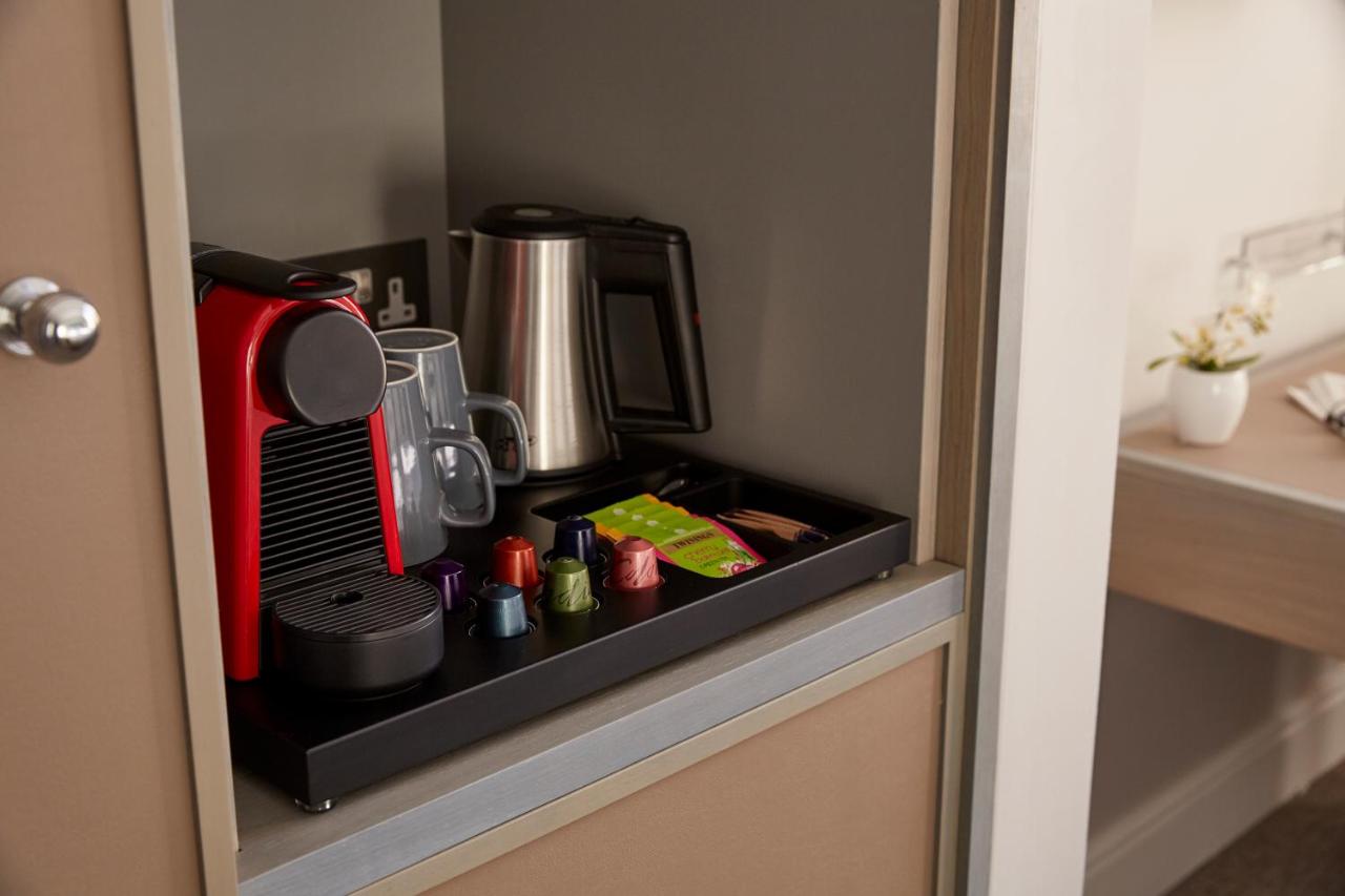 a cupboard with a coffee maker on top of it at 54 Queen's Gate Hotel in London