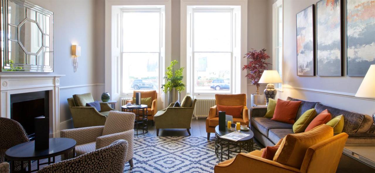 a living room with a couch and chairs at 54 Queen's Gate Hotel in London